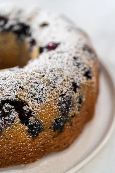 Dusting Freshly Baked Lemon Blueberry Bundt Cake Powdered Sugar — Stock Photo, Image