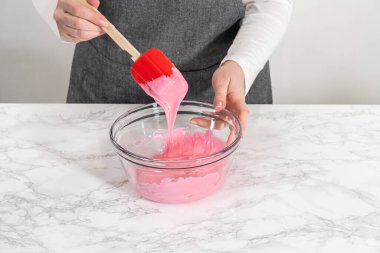 Ev yapımı kraliyet kreması yapmak için büyük bir cam karıştırma kabında malzemeleri karıştırıyorum..