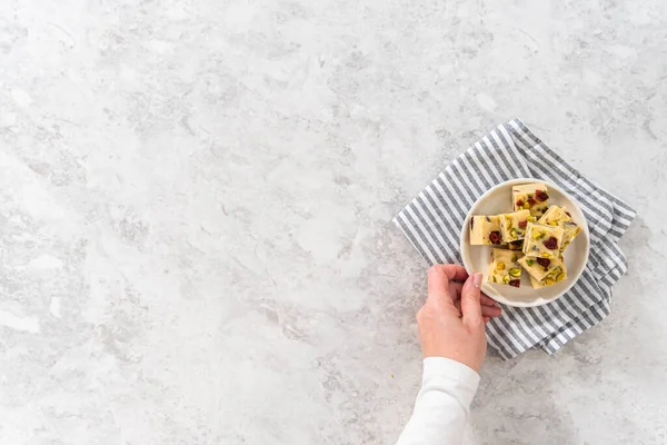 Flat Lay Homemade Cranberry Pistachio Fudge Square Pieces White Plate — Stock Photo, Image