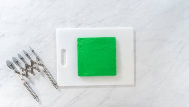 Düz yatıyordu. Kesmek için yeşil şekerlemeleri mükemmel karelere çevirmek.