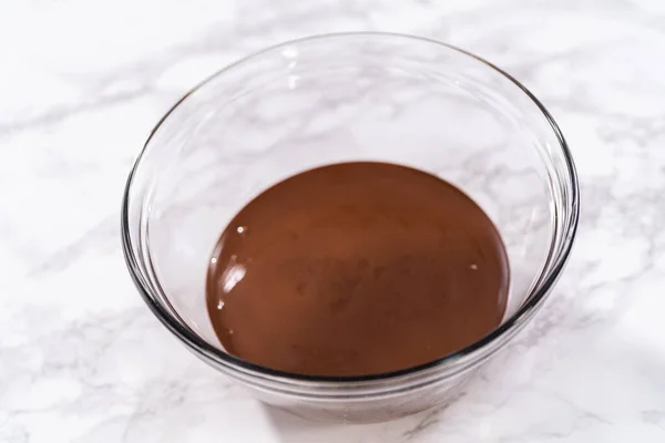 チョコレートで覆われたイチゴを準備するためにガラス混合ボウルに溶かしたチョコレート — ストック写真