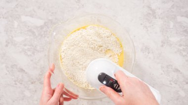 Düz yatıyordu. Adım adım. Fünyeli kek pişirmek için karıştırma kabındaki malzemeleri karıştırıyorum..