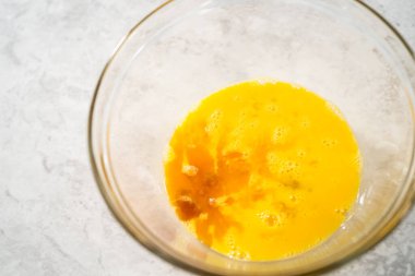 Çikolatalı kurabiyeleri naneli cipsle karıştırmak için büyük bir bardaktaki malzemeleri karıştırıyorum..