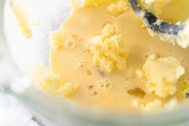 Mixing ingredients in kitchen electric mixer to bake American flag mini cupcakes.