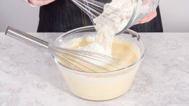 Adım adım. Hindistancevizli muzlu krep hazırlamak için cam karıştırma kabında malzemeleri karıştırıyorum..