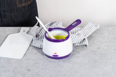 Çikolata parçacıkları eriyip, havuç kaplı kraker yapmak için şeker tenceresinde eritmek..