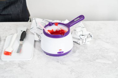 Çikolata parçacıkları eriyor elektrikli şeker tenceresinde.