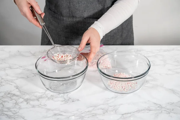 Sifting Crushed Peppermint Candies Spider Strainer Glass Mixing Bowls — Stock Photo, Image