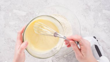 Düz yatıyordu. Adım adım. Fünyeli kek pişirmek için karıştırma kabındaki malzemeleri karıştırıyorum..