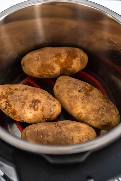 Pressure Cooker Baked Potatoes. Cooking whole potatoes in a pressure cooker to make baked potatoes.