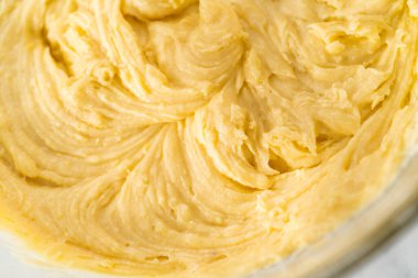 Limonlu yaban mersinli kek yapmak için büyük bir bardakta karıştırma malzemesi..