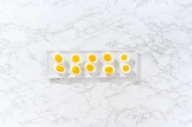 Beyaz servis tabağında dilimlenmiş haşlanmış yumurta..