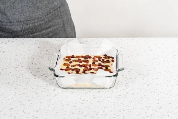 Removing White Chocolate Cranberry Pecan Fudge Baking Pan Lined Parchment — Stock Photo, Image