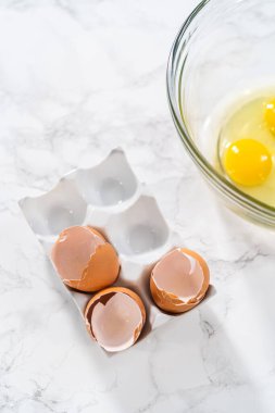 Measured ingredients in glass mixing bowls to bake American flag mini cupcakes.
