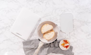 Flat lay. Prepare provolone and apple grilled cheese sandwich on a nonstick frying pan.