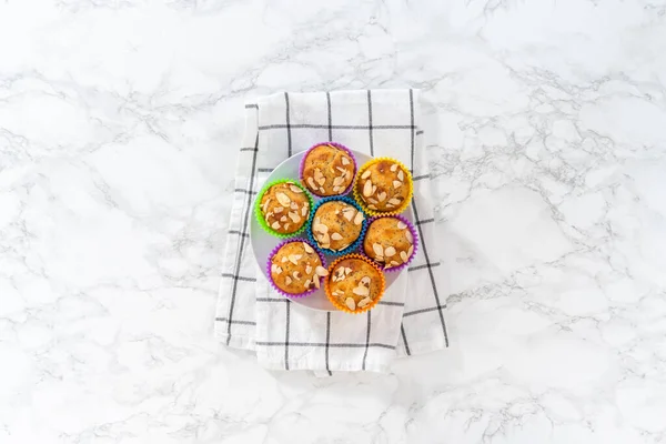 平置きだ 焼きたてのレモンケシの種マフィンは キッチンカウンターにアーモンドのスライバーで飾られています — ストック写真