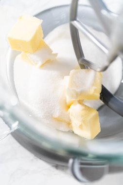 Mixing ingredients in kitchen electric mixer to bake American flag mini cupcakes.