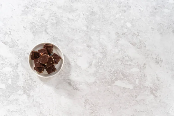 Deitado Pedaços Quadrados Chocolate Caseiro Macadâmia Fudge Uma Placa Branca — Fotografia de Stock