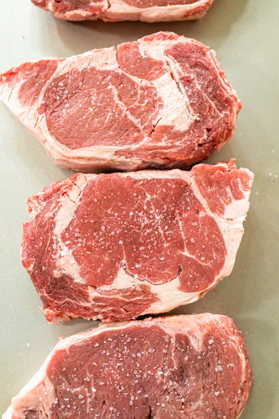 Situated Modern White Kitchen Seasoned Rib Eye Steak Boasting Its — стоковое фото