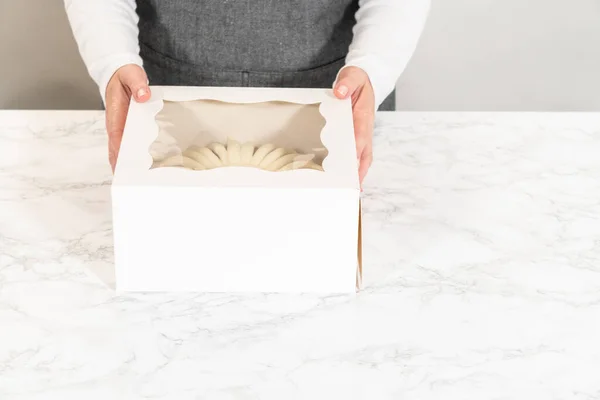 The Carrot Bundt Cake is carefully packaged into a white paper bundt cake box, ready for gifting or sharing.