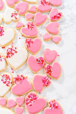 Sevgililer Günü için pembe ve beyaz kraliyet kremalı kalp şeklinde kurabiyeler..