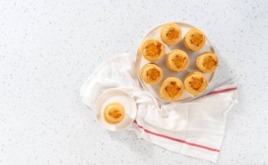 Flat lay. Freshly baked dulce de leche cupcakes on a kitchen counter.