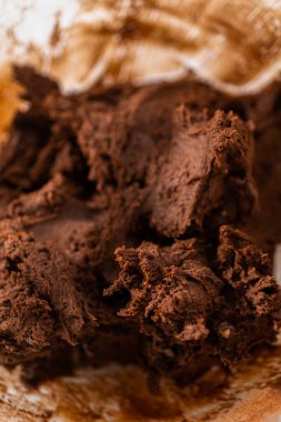 Mixing ingredients with a hand mixer to bake chocolate cookies with chocolate hearts for Valentines Day.