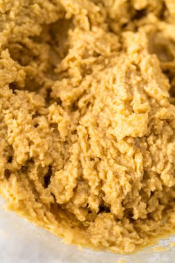 Mixing ingredients with a hand mixer to bake chocolate cookies with chocolate hearts for Valentines Day.