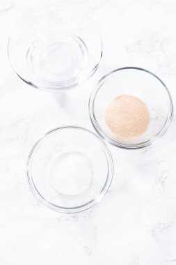 Ingredients to activate instant yeast in small glass bowls.