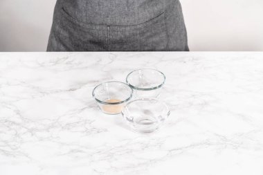 Ingredients to activate instant yeast in small glass bowls.
