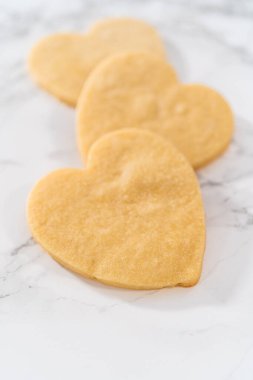 Sevgililer Günü için pembe ve beyaz kraliyet kremalı kalp şeklinde kurabiyeler..