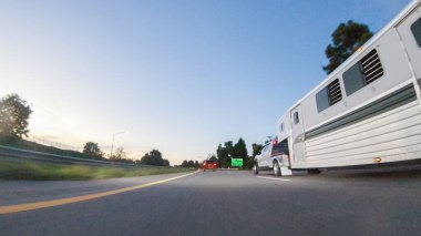 Los Angeles, California, ABD-4 Aralık 2022-POV-Güneş batarken, Pismo Sahili yakınlarında HWY 101 'de araba sürmek turuncu ve pembe tonlarda gökyüzü ile büyüleyici bir deneyim haline geliyor.