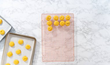 Lemon Cookies with White Chocolate. Flat lay. Cooling freshly baked lemon cookies with white chocolate on a kitchen counter.