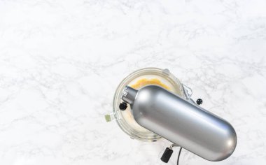 Flat lay. Mixing ingredients in kitchen electric mixer to bake American flag mini cupcakes.