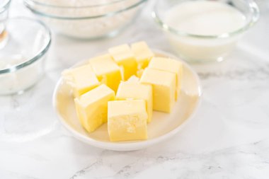 Measured ingredients in glass mixing bowls to bake American flag mini cupcakes.