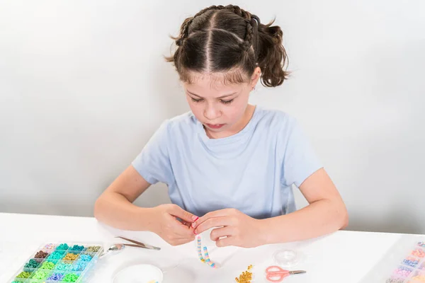 Little Girl Enjoys Crafting Colorful Bracelets Vibrant Clay Beads Set — Stock Photo, Image
