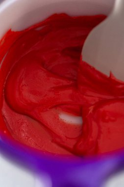 Melting red chocolate chips in a candy melting pot to make chocolate lips and heart shaped chocolates for Valentines Day.