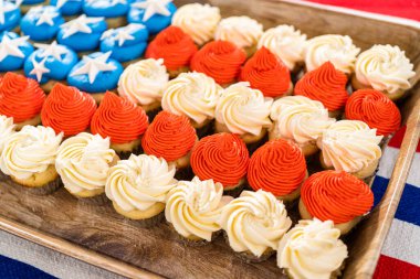 Arranging mini vanilla cupcakes in the shape of the American flag.