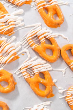 Çikolata soslu krakerlerin üzerine erimiş çikolata serpiştirmek..