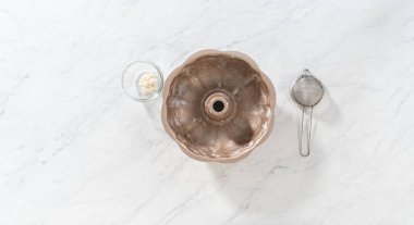 Düz yatıyordu. Limonlu kek pişirmek için sebze boyası ve un ile yağlı metal kek tepsisi..