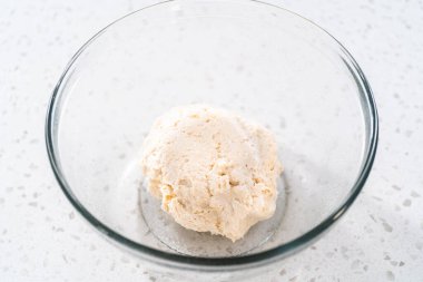 Cam bir kasede yükselen hamurlar naan dippers pişirmek için karıştırılıyor..