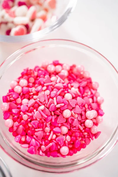 stock image Measured ingredients in glass mixing bowls to make chocolate covered pretzel rods for Valentines Day.