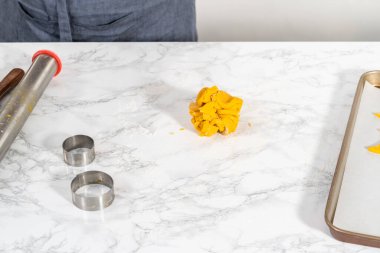 Limon jöleli limonlu kurabiye. Kurabiye hamurunu ayarlanabilir merdaneyle yuvarlamak ve limon jöleli kurabiye pişirmek için kurabiye kesmek..