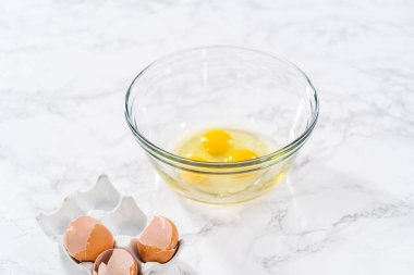 Measured ingredients in glass mixing bowls to bake American flag mini cupcakes.