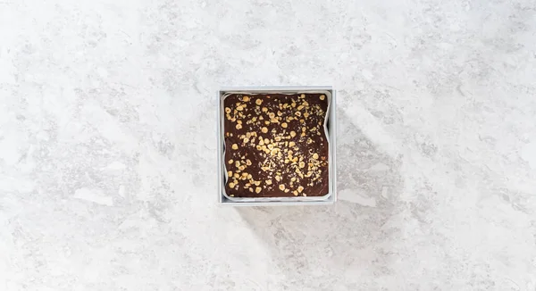 Flat Lay Removing Chocolate Hazelnut Fudge Square Cheesecake Pan Lined — Stock Photo, Image