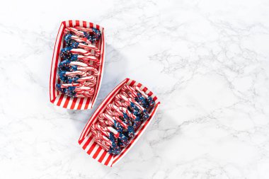 Flat lay. American flag. Red, white, and blue chocolate-covered pretzel twists.