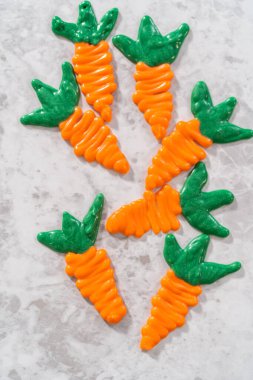 Chocolate carrot cake toppers on a kitchen counter.