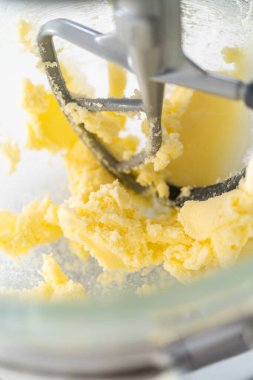 Mixing ingredients in kitchen electric mixer to bake American flag mini cupcakes.