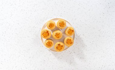 Flat lay. Freshly baked dulce de leche cupcakes on a kitchen counter.