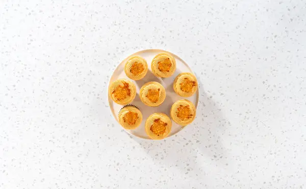 Flat lay. Freshly baked dulce de leche cupcakes on a kitchen counter.